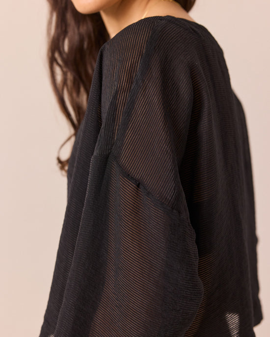 model wears lily black sheer stripe top