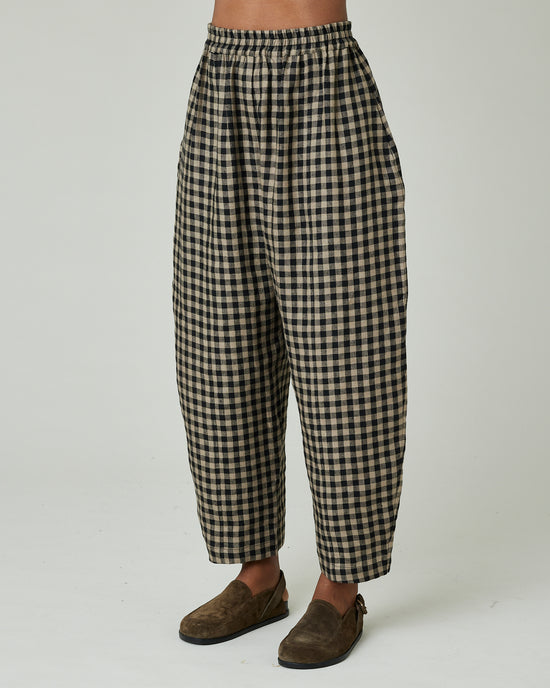 model wears coffee gingham mabel trousers left