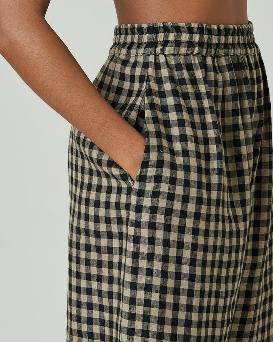 model wears coffee gingham mabel trousers 