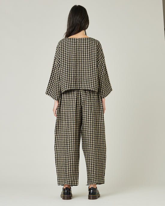 model wears black and ecru check mabel trousers