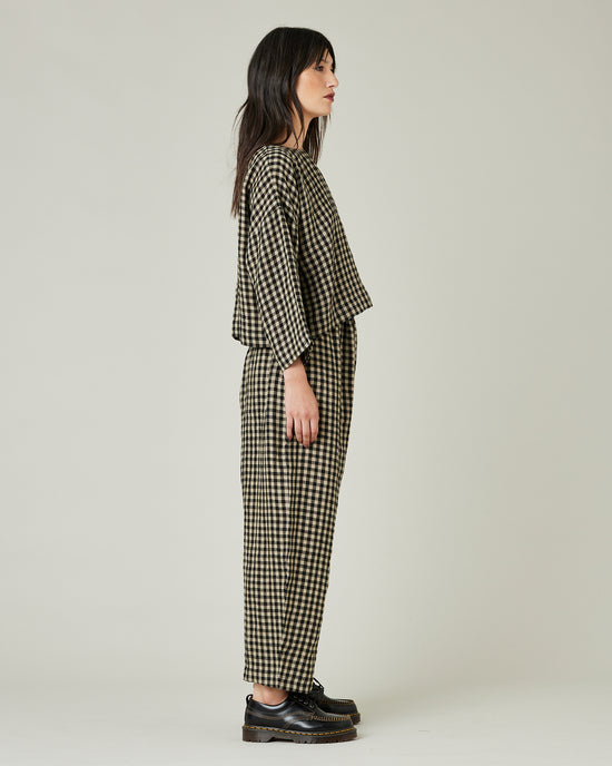 model wears black and ecru check mabel trousers