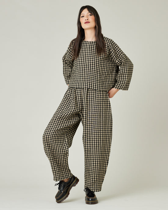 model wears black and ecru check mabel trousers