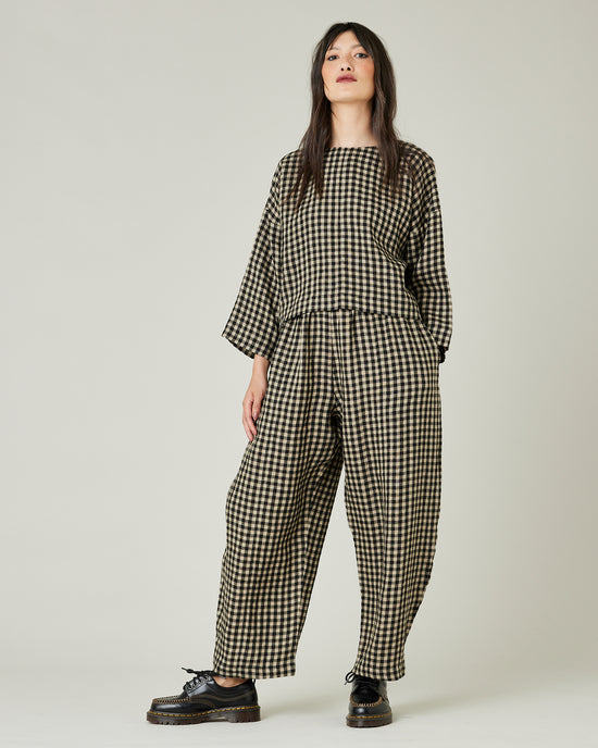 model wears black and ecru check mabel trousers