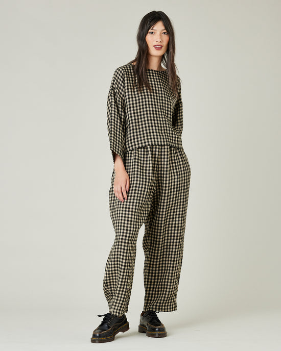 model wears black and ecru check mabel trousers