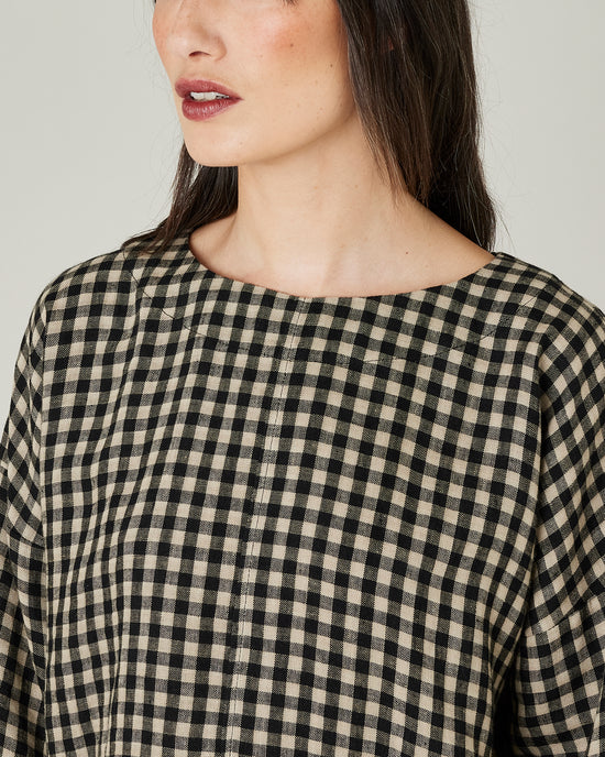 model wears lily black and ecru check top