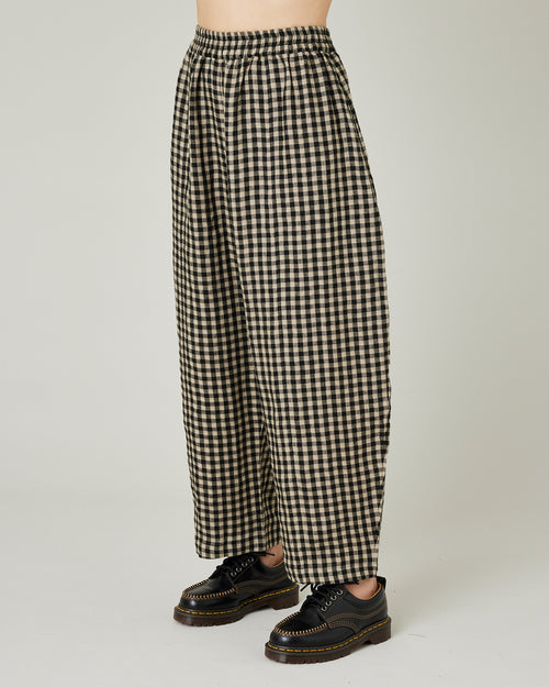 model wears black and ecru check mabel trousers left