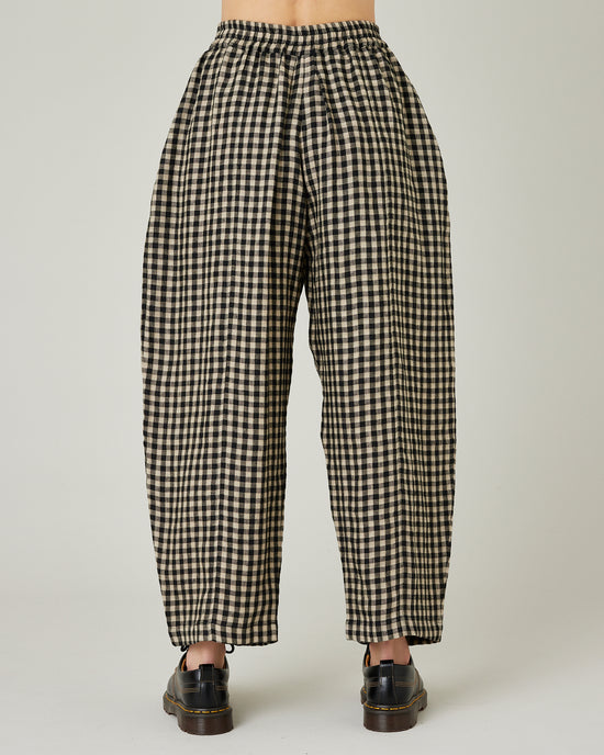 model wears black and ecru check mabel trousers back