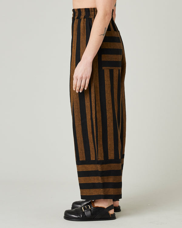 model wears rust stripe bobbi trousers left