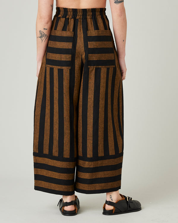 model wears rust stripe bobbi trousers back