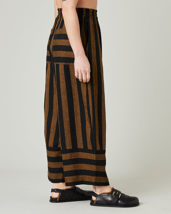 model wears rust stripe bobbi trousers right