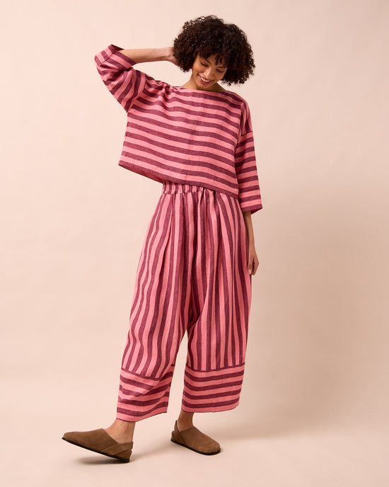 model wears lily fiesta pink linen top