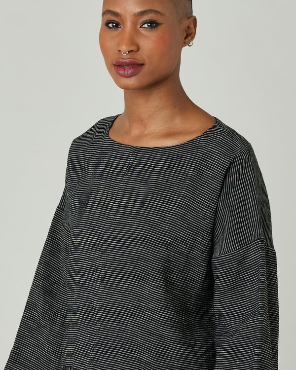 model wears black and ecru pencil stripe lily top 