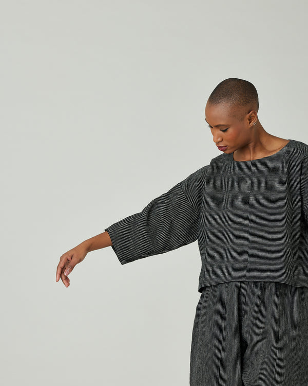 model wears black and ecru pencil stripe lily top 