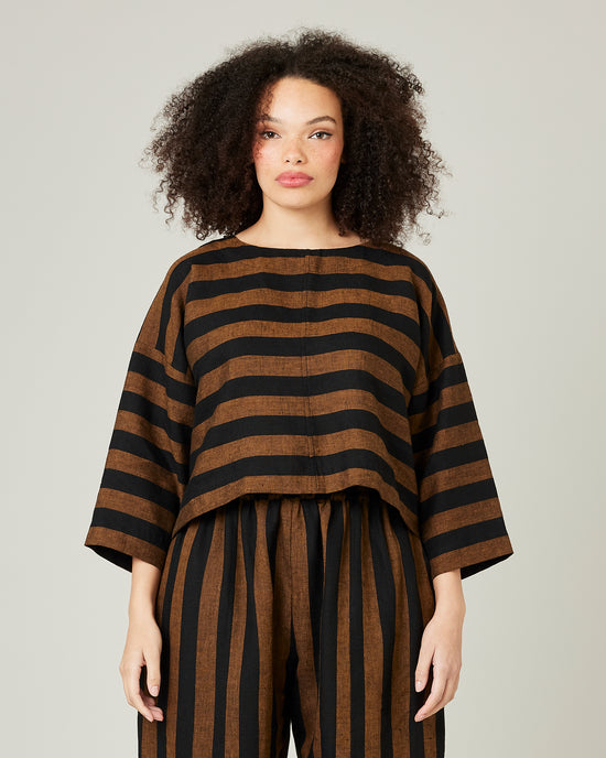 model wears linen rust and black stripe lily top