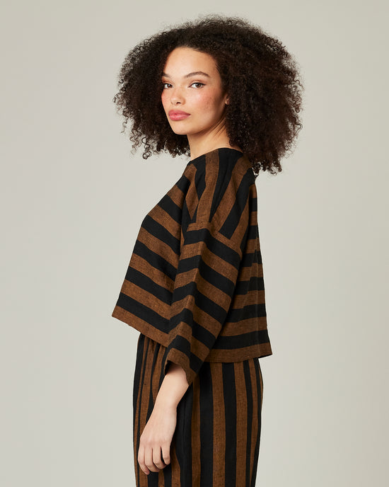 model wears linen rust and black stripe lily top