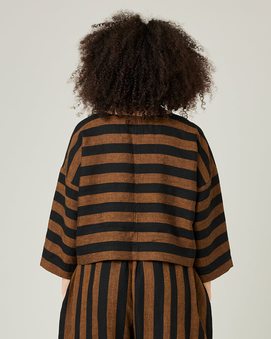 model wears linen rust and black stripe lily top