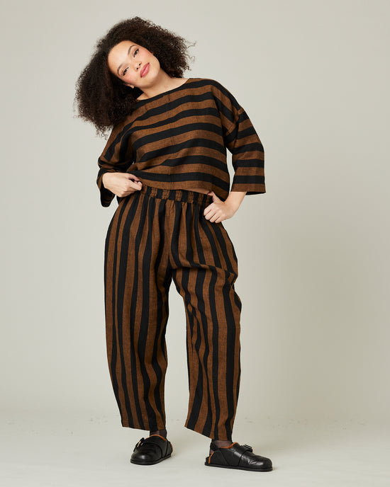 model wears linen rust and black stripe lily top