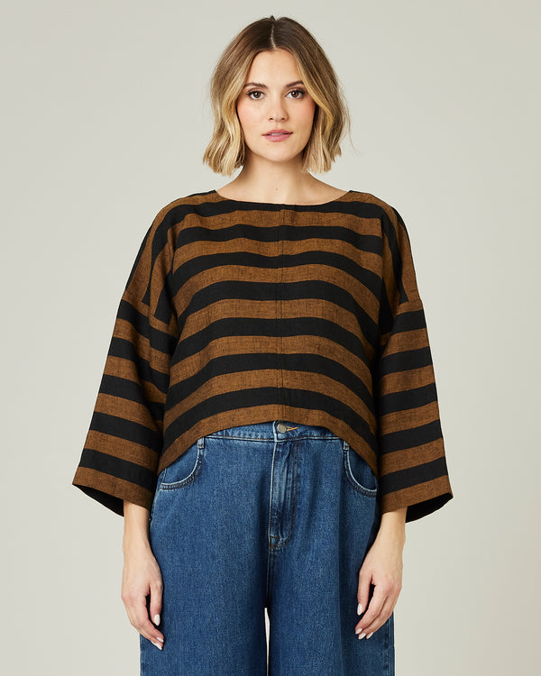 pregnant model wears linen rust and black stripe lily top