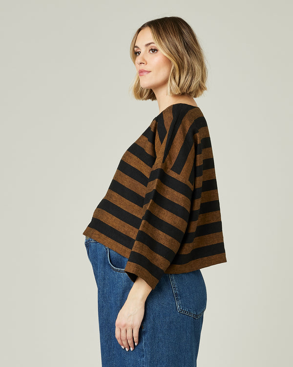pregnant model wears linen rust and black stripe lily top