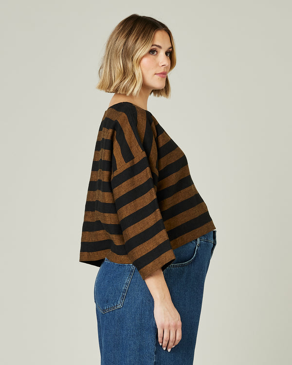 pregnant model wears linen rust and black stripe lily top
