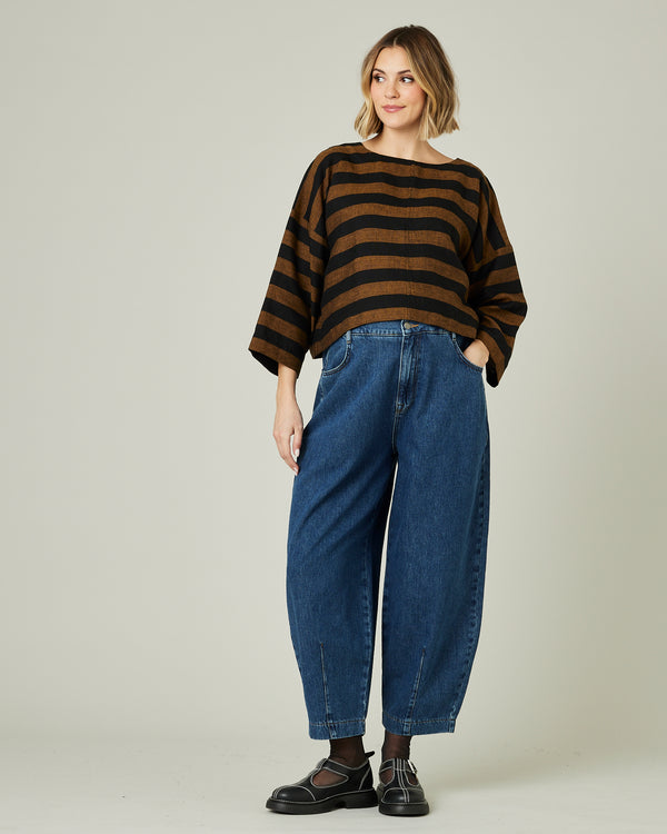 pregnant model wears linen rust and black stripe lily top