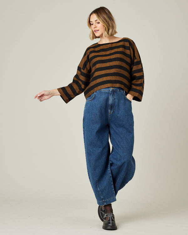 pregnant model wears linen rust and black stripe lily top