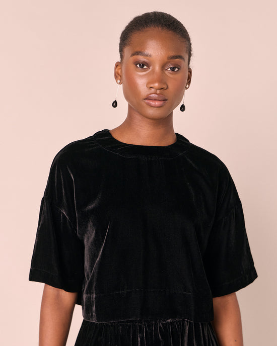 model wears the lisa black velvet top