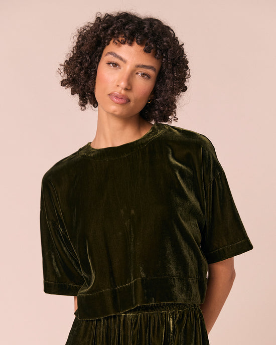 model wears lisa moss green velvet top