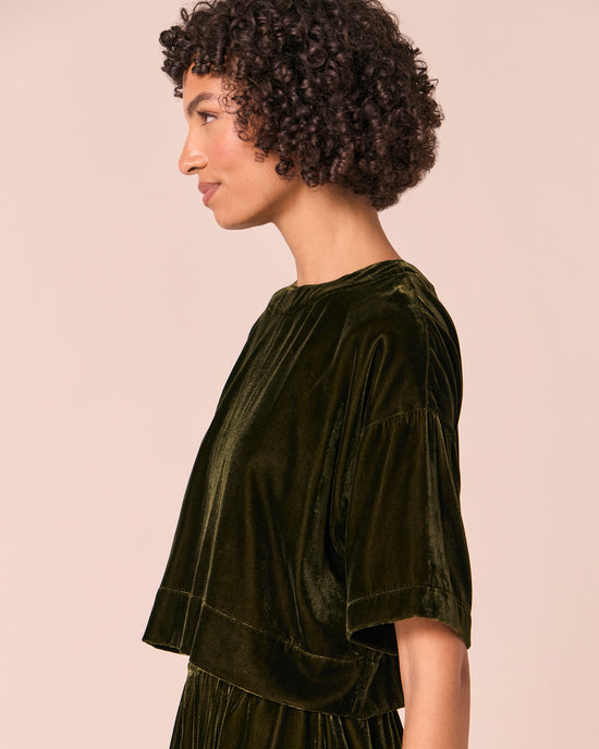 model wears lisa moss green velvet top