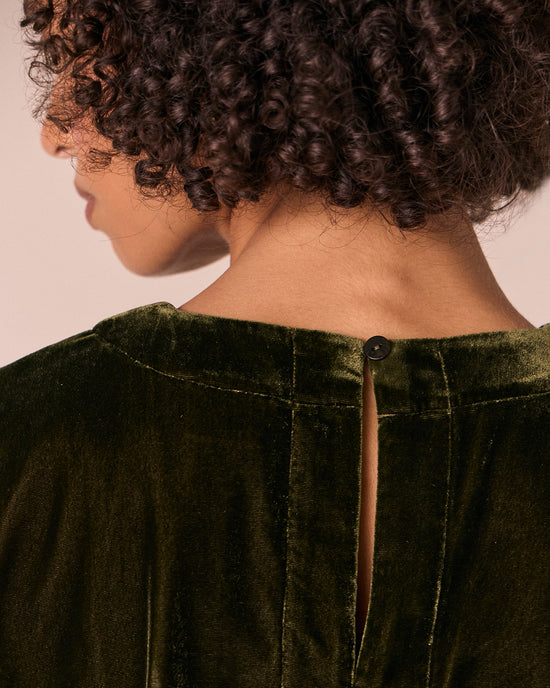 model wears lisa moss green velvet top