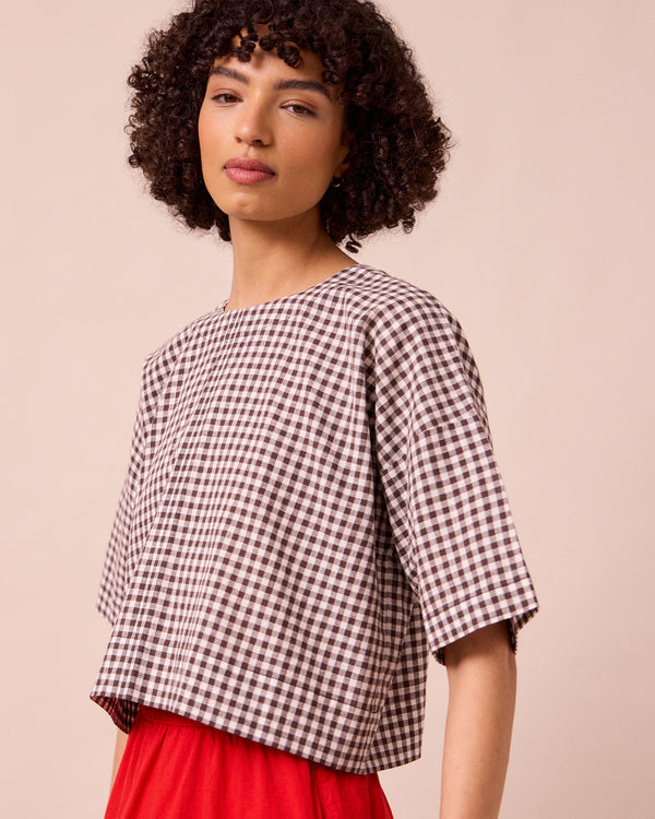 model wears lisa ganache gingham cotton linen top