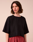 model wears lisa black linen top