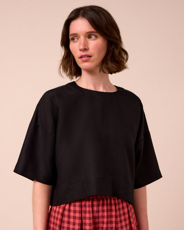 model wears lisa black linen top