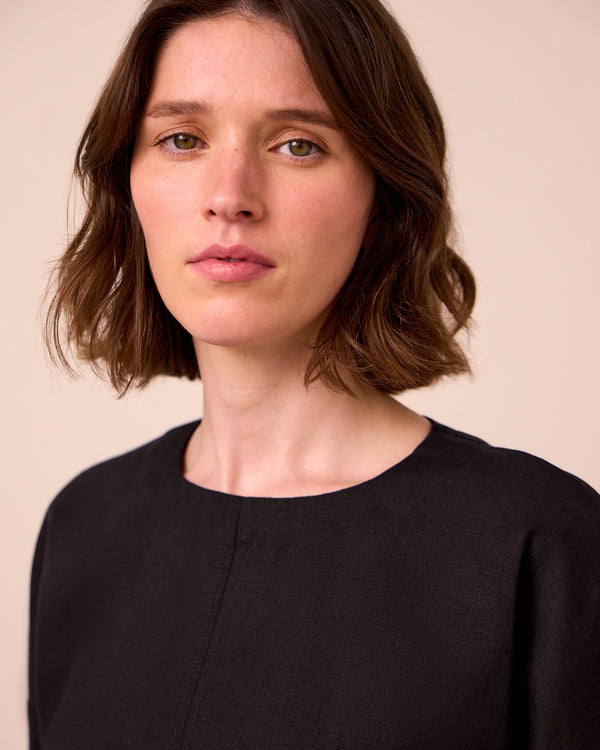 model wears lisa black linen top