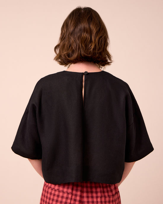 model wears lisa black linen top