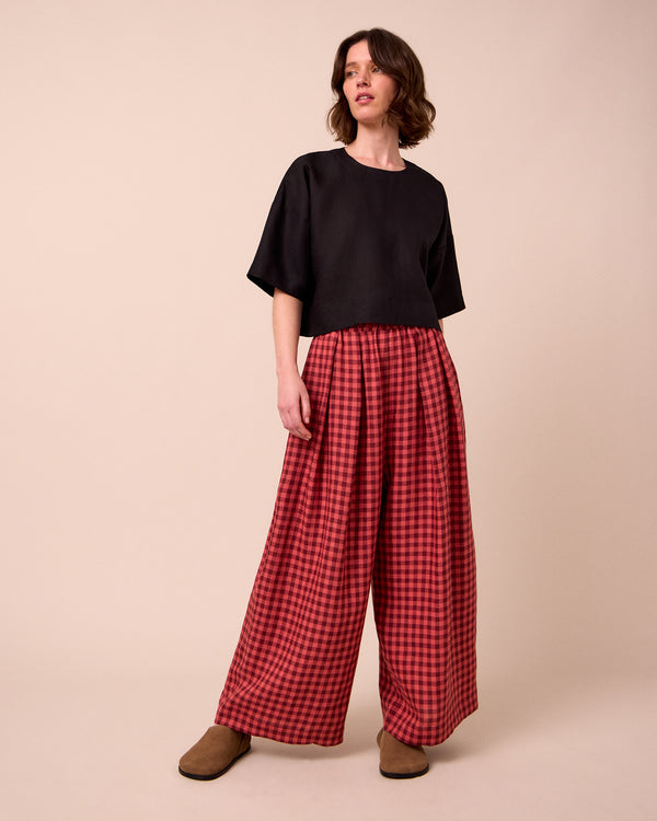 model wears lisa black linen top