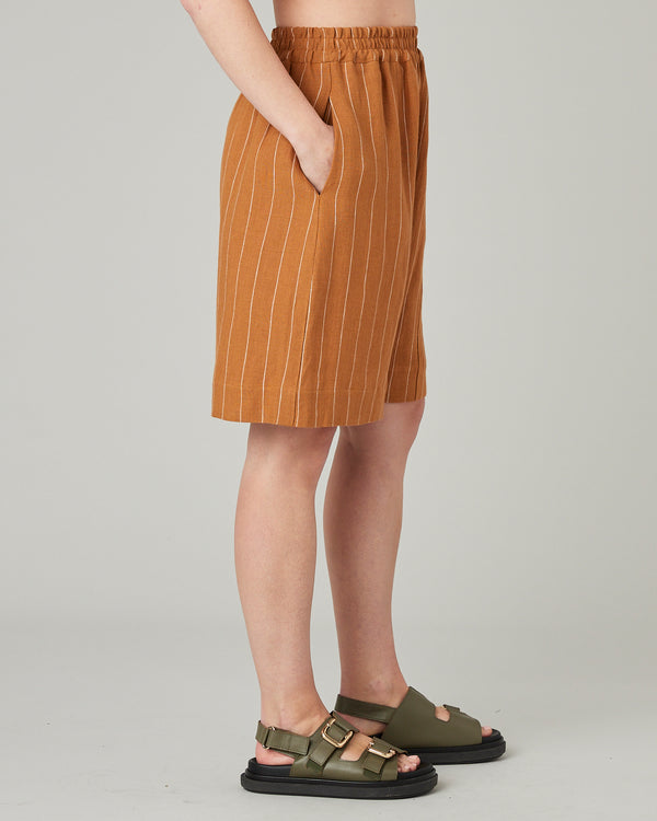 model wears honey stripe liv linen shorts