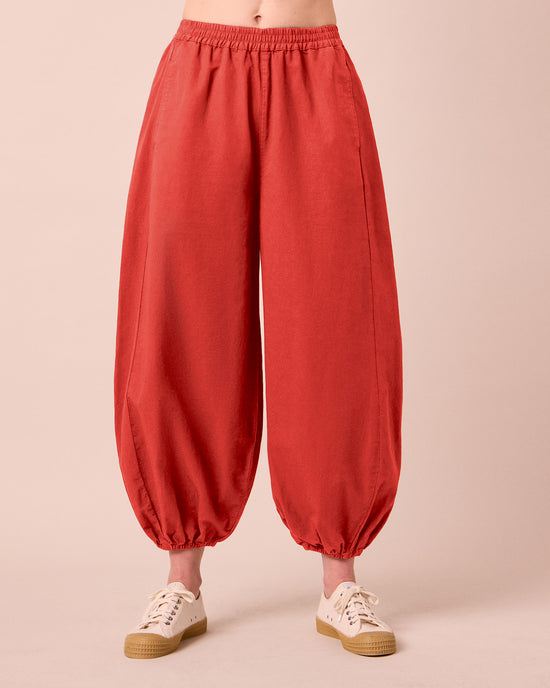 model wears logan brick cotton trousers front