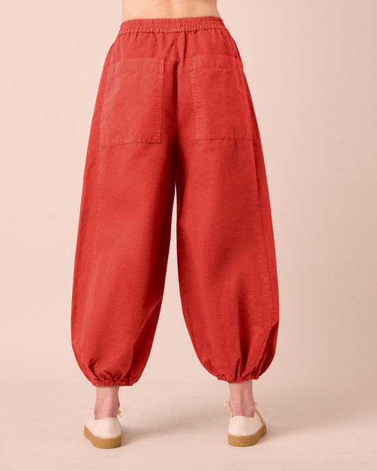 model wears logan brick cotton trousers back