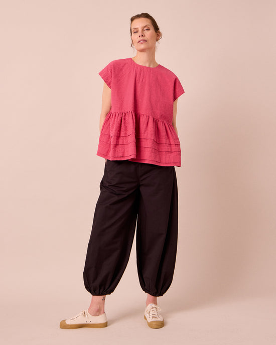 model wears logan cotton linen slub trousers left
