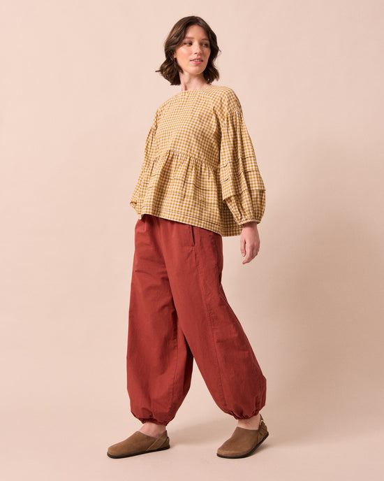 model wears logan brick cotton linen slub trousers left