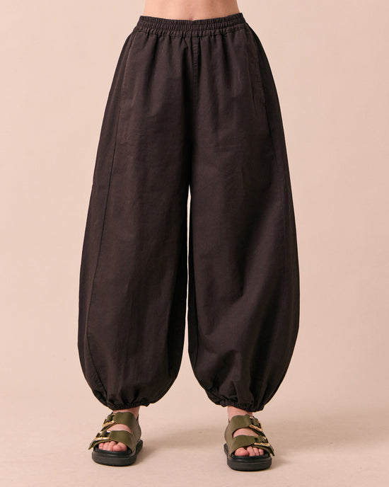 model wears logan ganache cotton trousers front