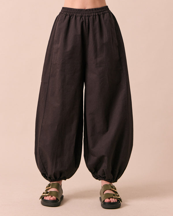 model wears logan ganache cotton trousers front