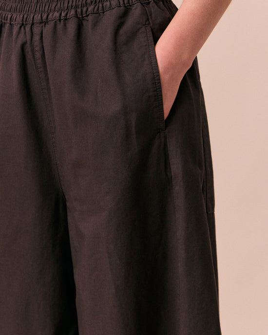 model wears logan ganache cotton trousers