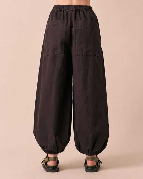 model wears logan ganache cotton trousers back