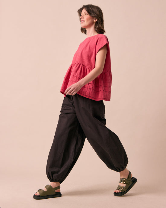 model wears logan ganache cotton trousers right