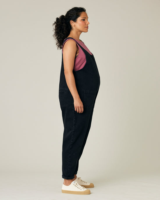 pregnant model wears black lola denim jumpsuit