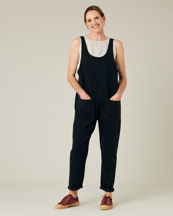 model wears black lola denim jumpsuit