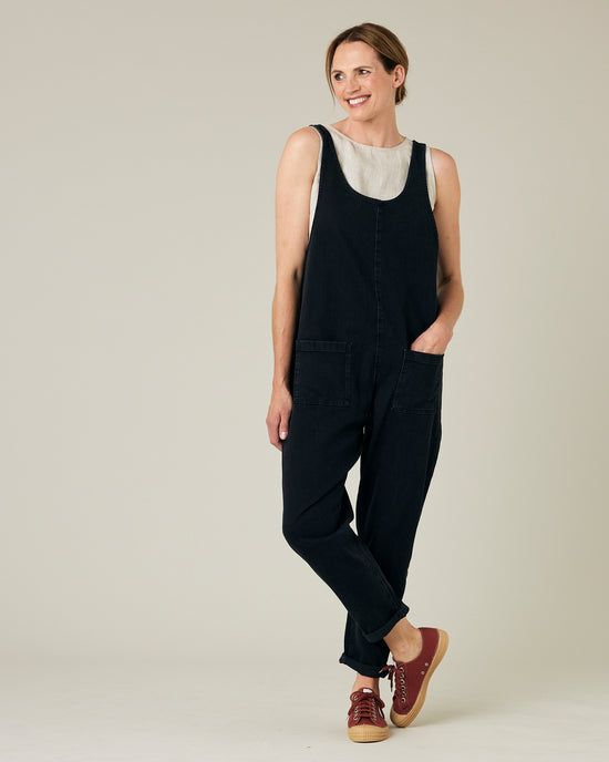 model wears black lola denim jumpsuit