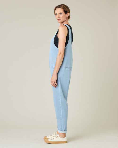 model wears light wash denim lola jumpsuit 